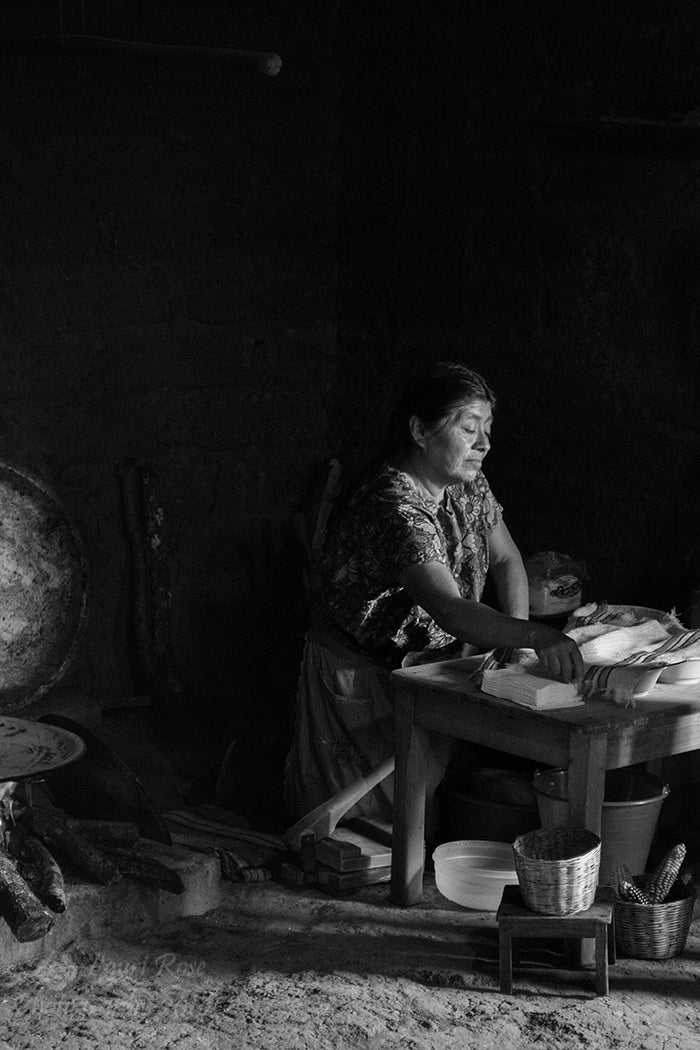 Black and White Photograph of woman cooking in Zincatan, Mexico.